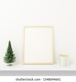 Interior Mock Up Golden Frame Design With Small Chrismas Tree And Present On White Concrete Background. 3D Rendering, Illustration.