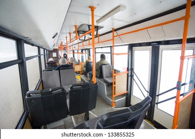 Interior Of Moder City Trolley Bus With Seat Places And Doors. WIde Angle Shot From Back Side