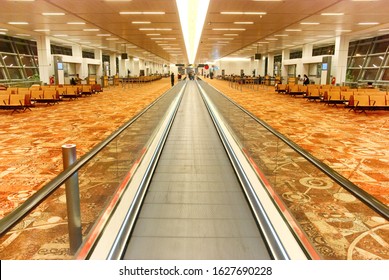 Interior of modern airport hall with the flat escalator