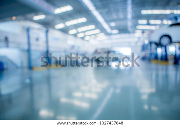 the interior of modern automotive dealership\
maintenance garage, out of\
focus