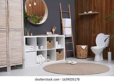 Interior of modern bathroom with round mirror