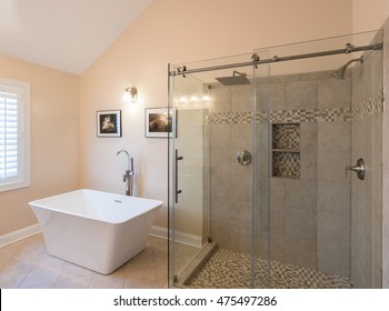 Interior Of Modern Bathroom With Standalone Tub Bath And Walk In Double Tiled Shower With Rain Head