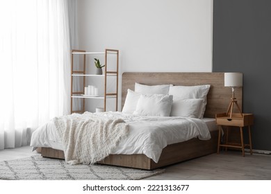 Interior of modern bedroom with big bed and shelving unit - Powered by Shutterstock