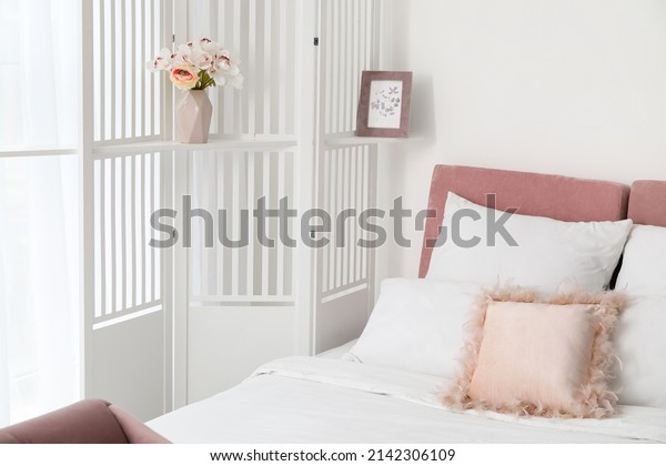 Interior of\
modern bedroom with stylish folding\
screen
