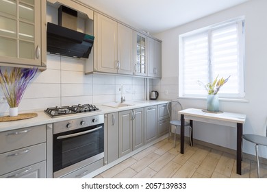 Interior Of A Modern Beige And Gray Kitchen In A Small Smart Apartment