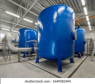 Interior of modern boiler room. Piping system. Large blue boiler units.