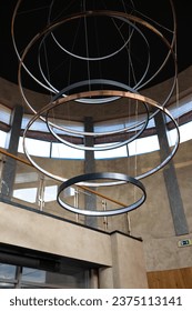 Interior of a modern building with a circular ceiling and a ceiling lamp