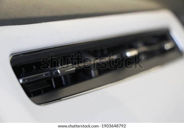 Interior of a modern car, Car Air\
Conditioner on console. The air flow inside the\
car.