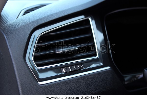 Interior of a modern car. Car\
conditioning. Vehicle vent interior for cold automobile cool. Auto\
climate condition. Hot air control panel. Car air\
conditioner.