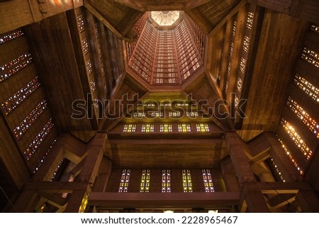 Interior of a modern church in Normandy France. Religious building built in reinforced concrete after the Second World War. High ceiling and bell tower with multicolored stained glass windows