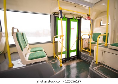 Interior Of Modern City Bus. Seat Places And Door In Back Side Of Bus. Wide Angle Shot