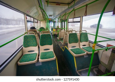 Interior Of Modern City Bus. Wide Angle Shot Of Back Side With Seat Places