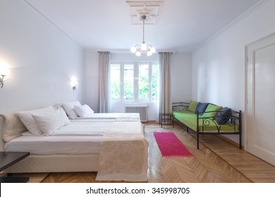 Interior Of Modern Comfortable Hotel Room With Double Bed And Green Sofa