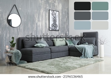 Interior of modern comfortable room with grey sofa. Different color patterns