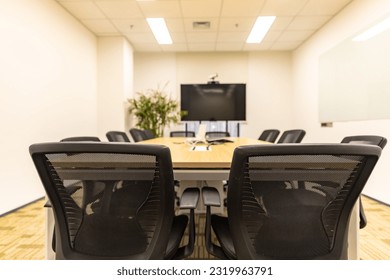 Interior of modern conference room with conference tables and chairs and multimedia equipment - Powered by Shutterstock