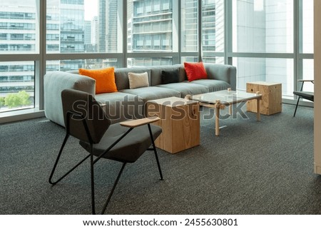 Interior of modern empty office building.Open ceiling design.There are floor-to-ceiling Windows and comfortable sofas