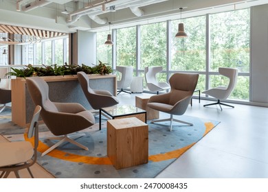 Interior of modern empty office lobby.Open ceiling design.There are floor-to-ceiling Windows and comfortable sofa, chairs and table. - Powered by Shutterstock