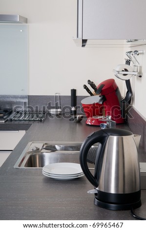 Interior of a modern grey and white kitchen with some kitchen attributes.