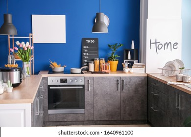 Interior Of Modern Kitchen With Blue Wall