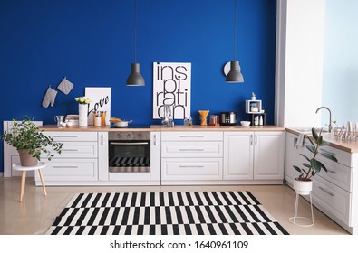 Interior Of Modern Kitchen With Blue Wall