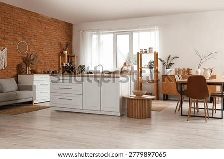 Interior of modern  kitchen with brick wall