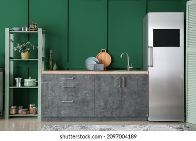 Interior Of Modern Kitchen With Fridge And Green Wall