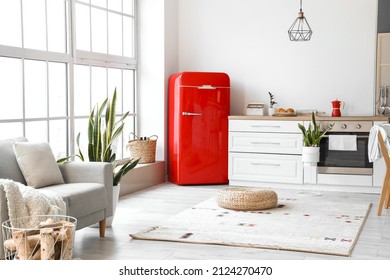 Interior Of Modern Kitchen With Red Fridge And White Counters