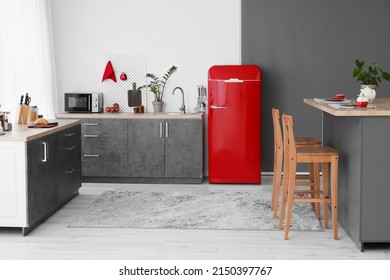 Interior Of Modern Kitchen With Red Fridge, Counters And Pegboard