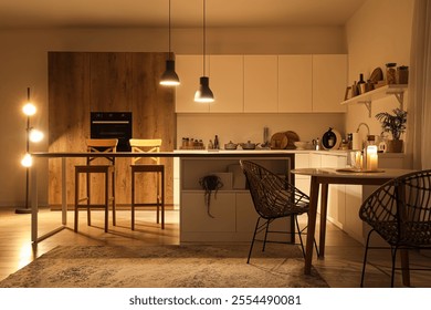 Interior of modern kitchen with tables, counters and glowing lamps in evening