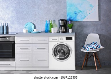 Interior Of Modern Kitchen With Washing Machine. Laundry Day