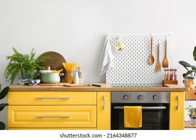 Interior Of Modern Kitchen With Yellow Furniture, Oven And Peg Board