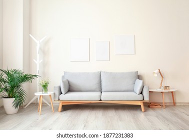 Interior of modern living room with comfortable sofa - Shutterstock ID 1877231383
