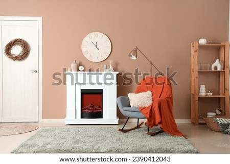 Interior of modern living room with fireplace and rocking chair