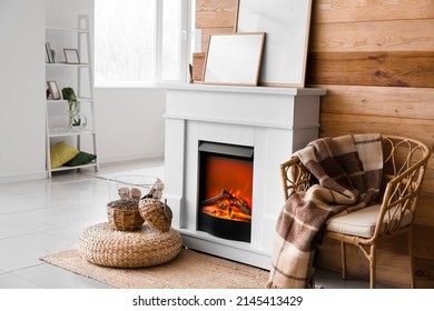 Interior Of Modern Living Room With Mantelpiece, Firewood And Frames