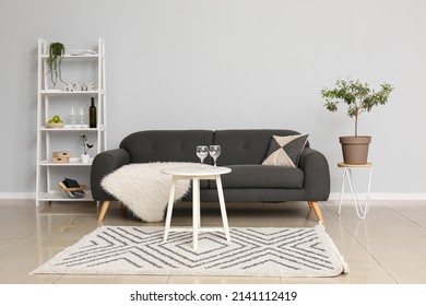 Interior Of Modern Living Room With Sofa, Table And Shelving Unit