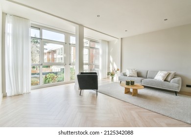 Interior Of Modern Living Room With A Wall Filled With Windows