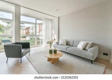 Interior Of Modern Living Room With A Wall Filled With Windows