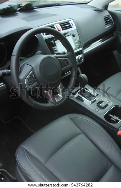 Interior of a modern luxury brand car, black\
leather and metal