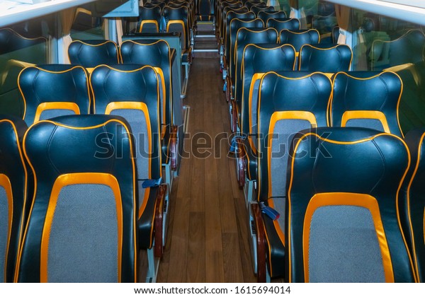 Interior of a modern passenger bus. Seats\
on the Bus. Passenger transport. Sightseeing transportation. Elite\
bus. Seats in passenger vehicles. Transportation of people.\
Intercity\
transportation