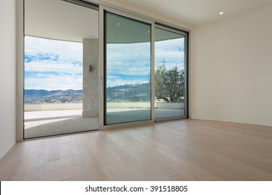 Interior of modern penthouse with wide terrace, empty room