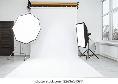 Interior of modern photo studio with professional lighting equipment - Shutterstock ID 2263614097