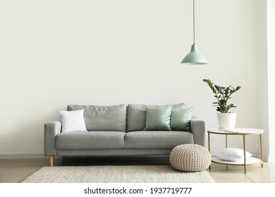 Interior of modern room with comfortable sofa - Shutterstock ID 1937719777