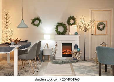 Interior Of Modern Room With Fireplace Decorated For Christmas