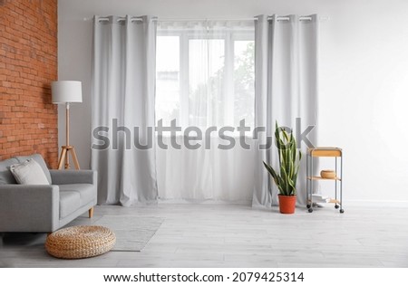 Interior of modern room with light curtains