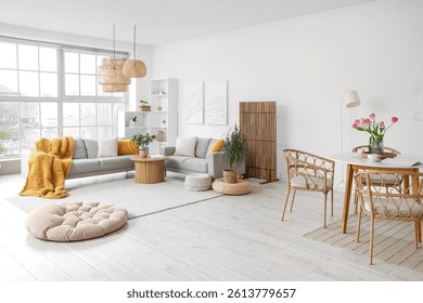 Interior of modern studio apartment with sofas and dining table