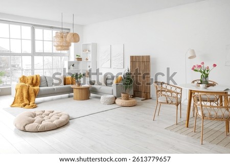 Interior of modern studio apartment with sofas and dining table