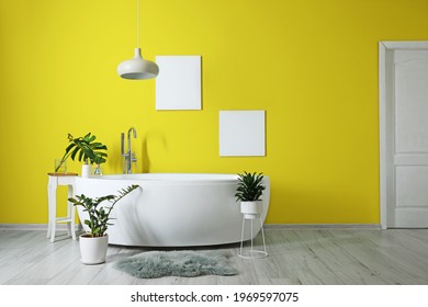 Interior Of Modern Stylish Bathroom With Yellow Wall