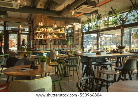 Interior of a modern urban restaurant in the morning sunlight