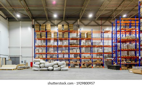 Interior of a modern warehouse storage of retail shop with pallet truck near shelves