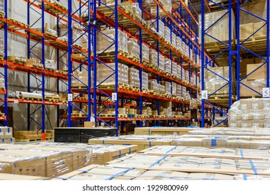 Interior of a modern warehouse storage of retail shop with pallet truck near shelves - Shutterstock ID 1929800969